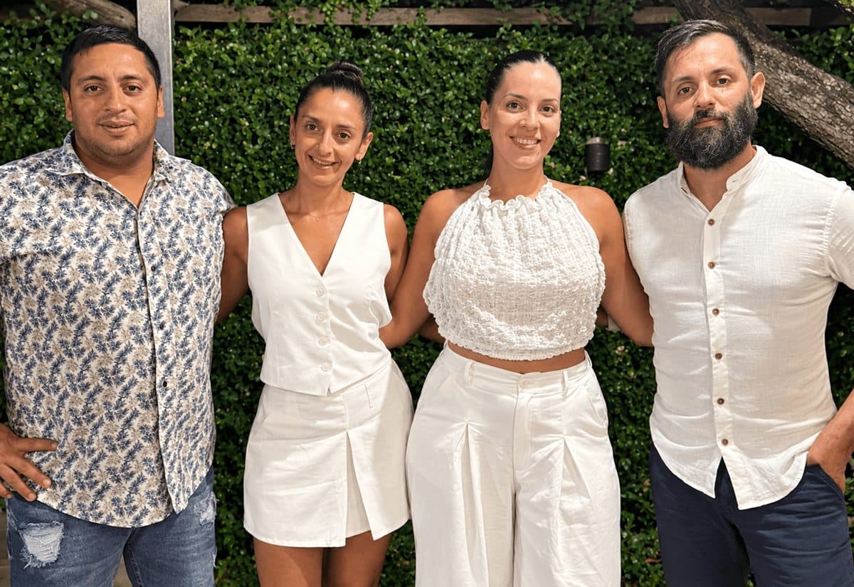Los cuatro hermanos que llevan adelante el catering, sonrientes y vestidos de blanco